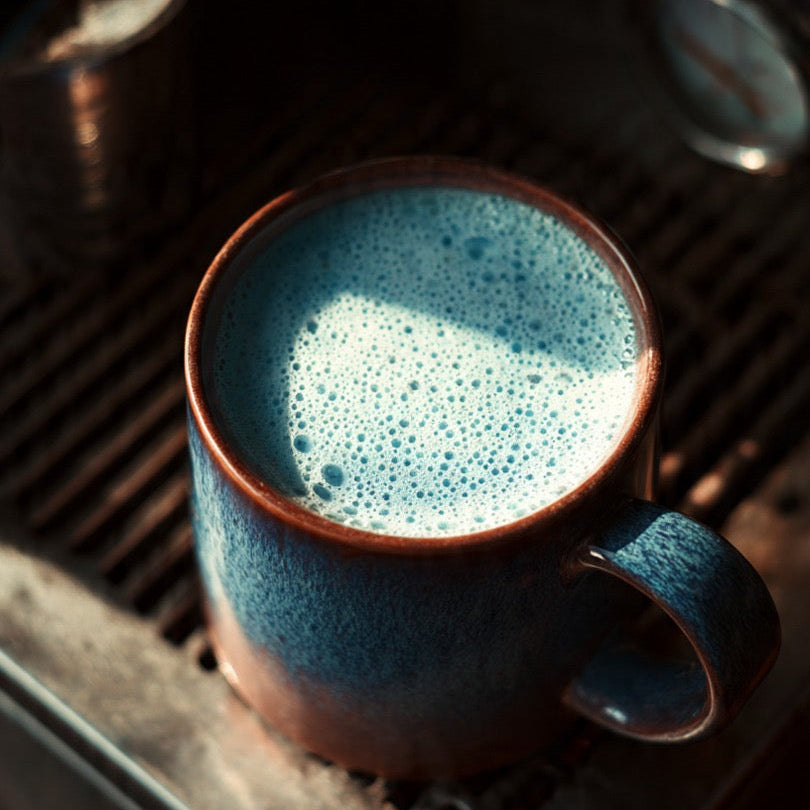 Frothy cup of Aumoe Rongoā Latte in a ceramic mug, showcasing the creamy latte topped with foam
