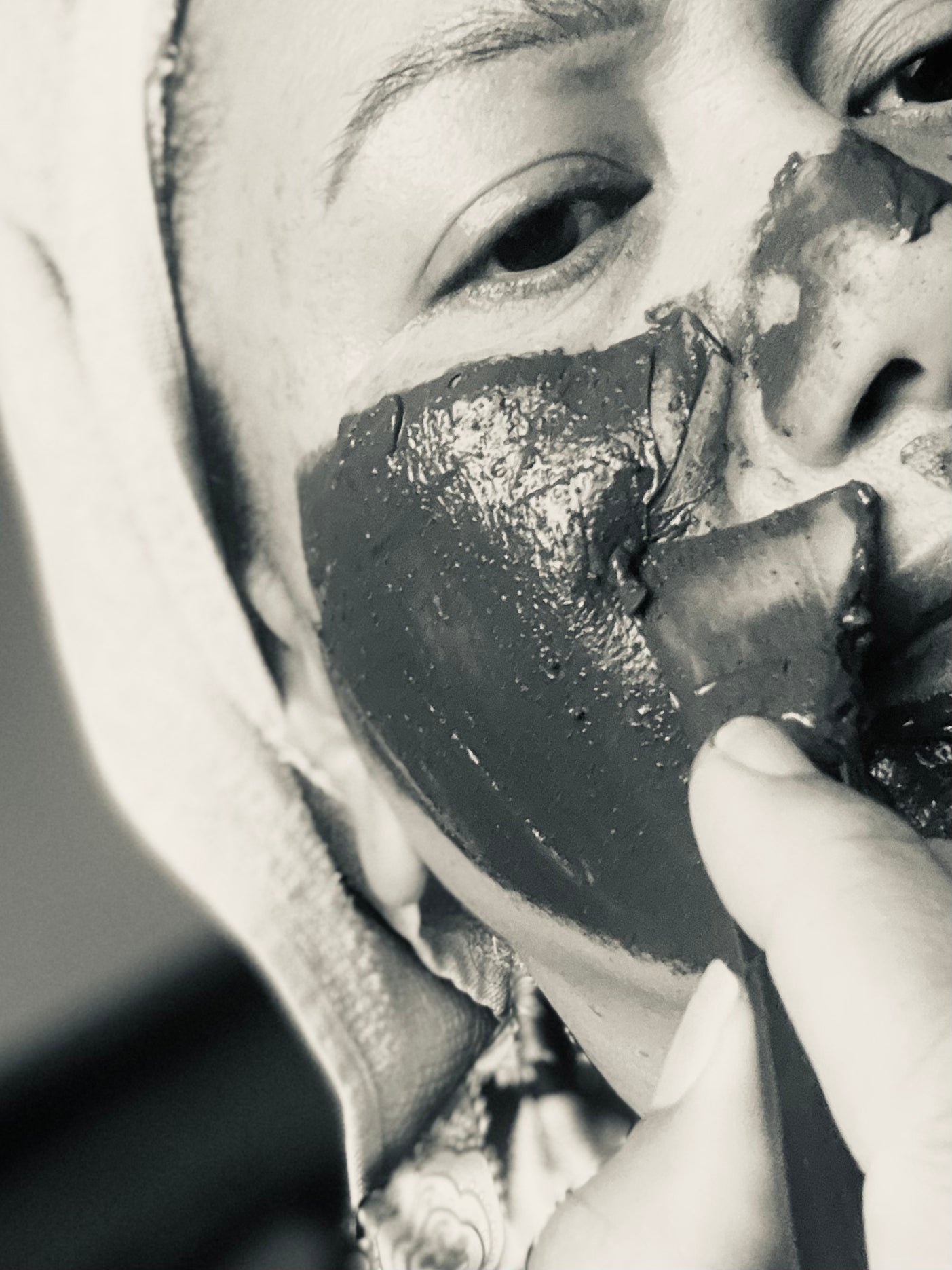 Applying Uku Detox Face Mask to face with silicone applicator