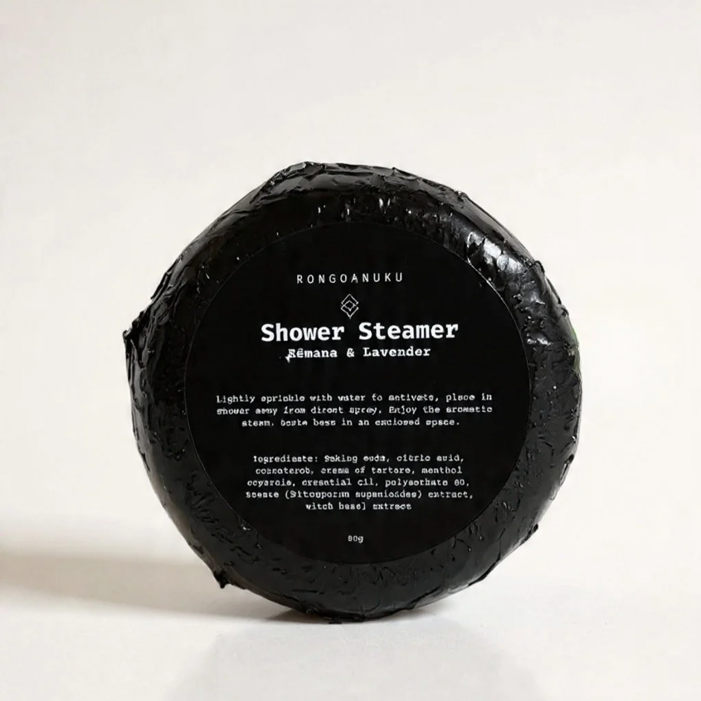 Shower steamer wrapped in black foil with product label sticker