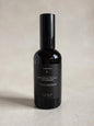Wharepaku toilet deodoriser spray in 120ml sleek black glass bottle, designed to spray into toilet water before use to prevent odours.