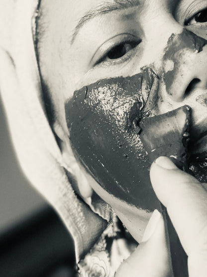 Applying Uku Detox Face Mask to face with silicone applicator