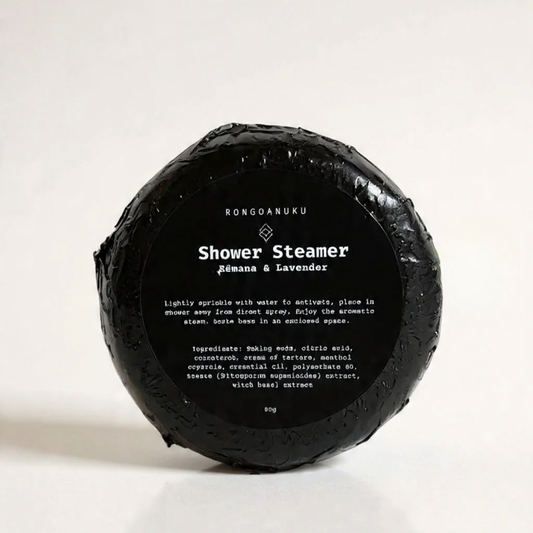 Shower steamer wrapped in black foil with product label sticker 