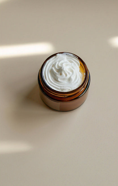 Brown jar with whipped tallow on a beige surface