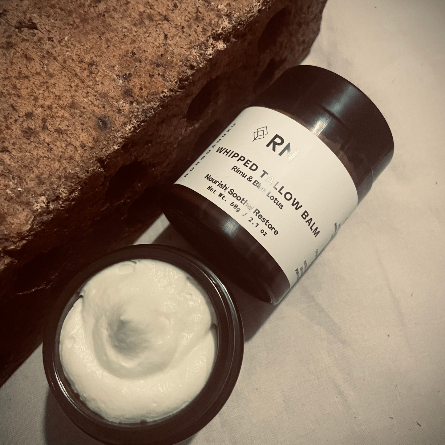 Open jar of whipped tallow balm with labelled jar beside it