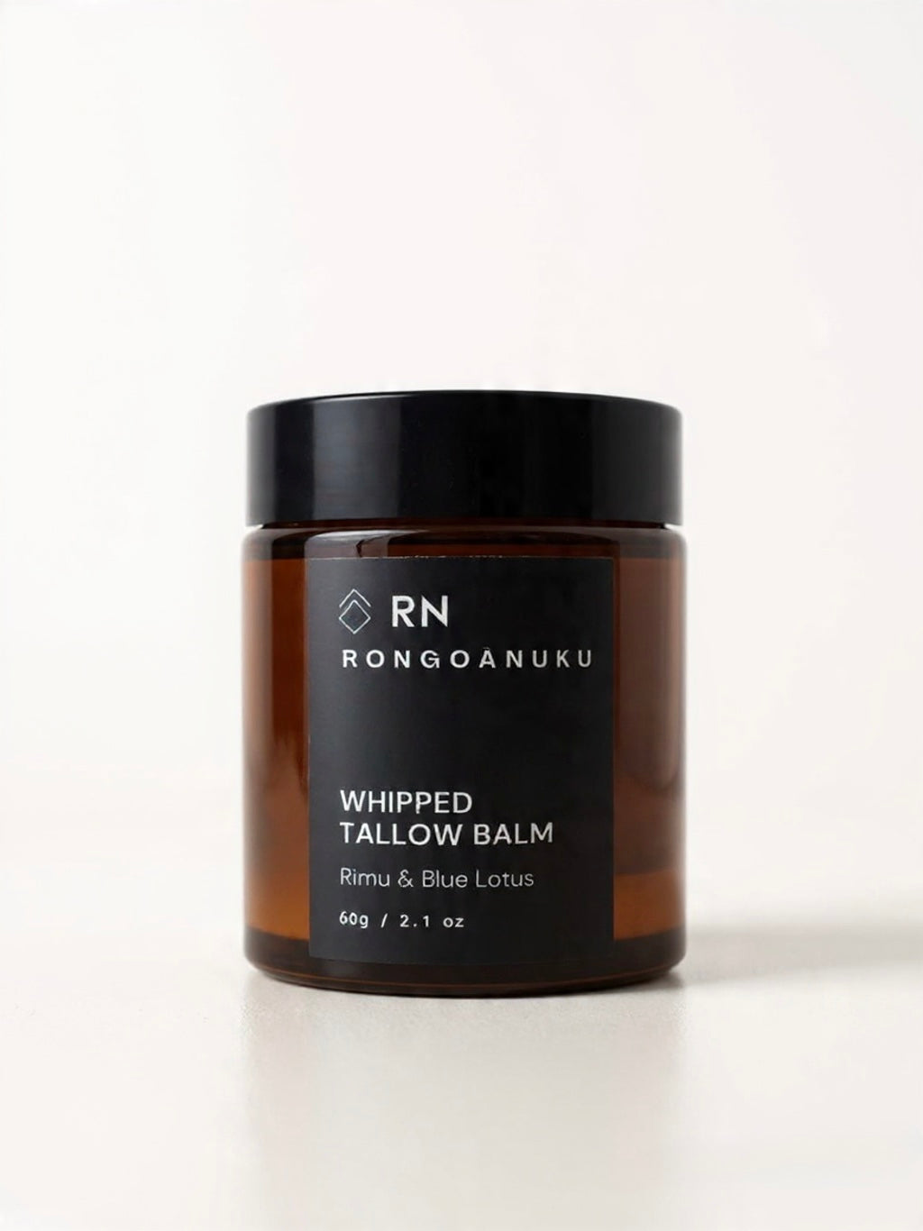 A brown jar of Rongoanuku rimu & blue lotus whipped tallow balm on a white background