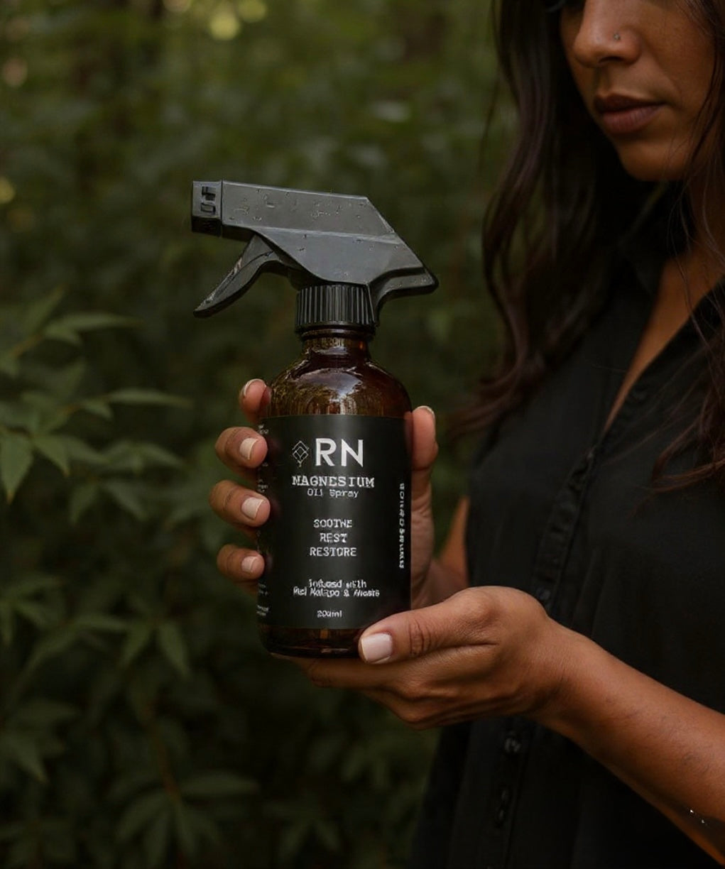 Person holding a bottle of 'RN' Mg OIl Spray 