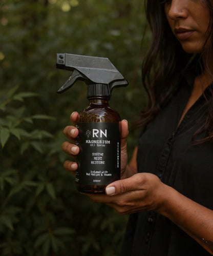 Person holding a bottle of 'RN' Mg OIl Spray 